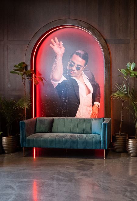 Iconic Salt Bae photo booth at Nusr-Et Beverly Hills, with a velvet sofa set against a backdrop of Nusret Gökçe, ideal for capturing luxury dining moments.