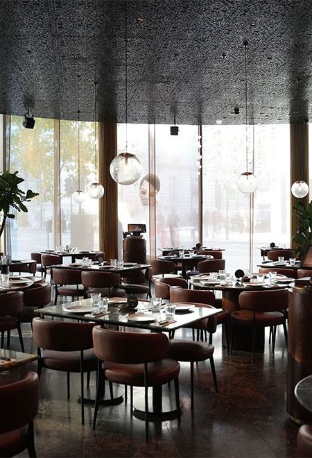 Elegant dining area at Nusr-Et London with floor-to-ceiling windows, modern decor, and comfortable seating for a premium steakhouse experience.