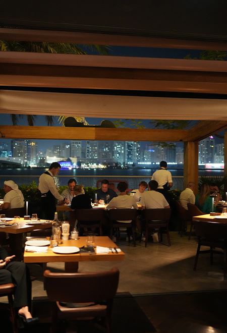 Nusr-Et Abu Dhabi waterfront restaurant: Guests savor premium steak dinners with a stunning view of the illuminated Abu Dhabi skyline