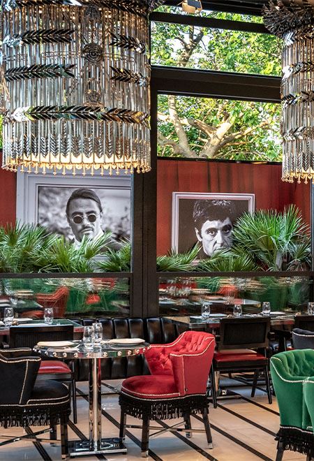 Artistic dining atmosphere at Nusr-Et Etiler, featuring modern artwork, lush greenery, and luxurious seating in a refined setting.