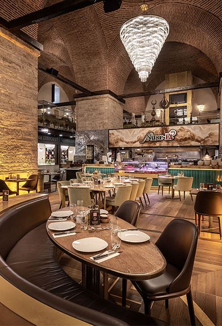 Grand central dining area under a vaulted ceiling at Nusret Kapalı Çarşı, Istanbul, offering a luxurious and unique steakhouse ambiance.